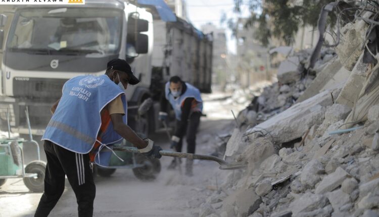 عمال الأونروا يعملون على إزالة الأنقاض في غزة.