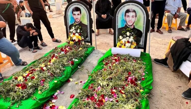 أشخاص يتجمعون أمام القبرين الرمزيين لجعفر سلطان (يسار) وصادق ثامر، في البحرين